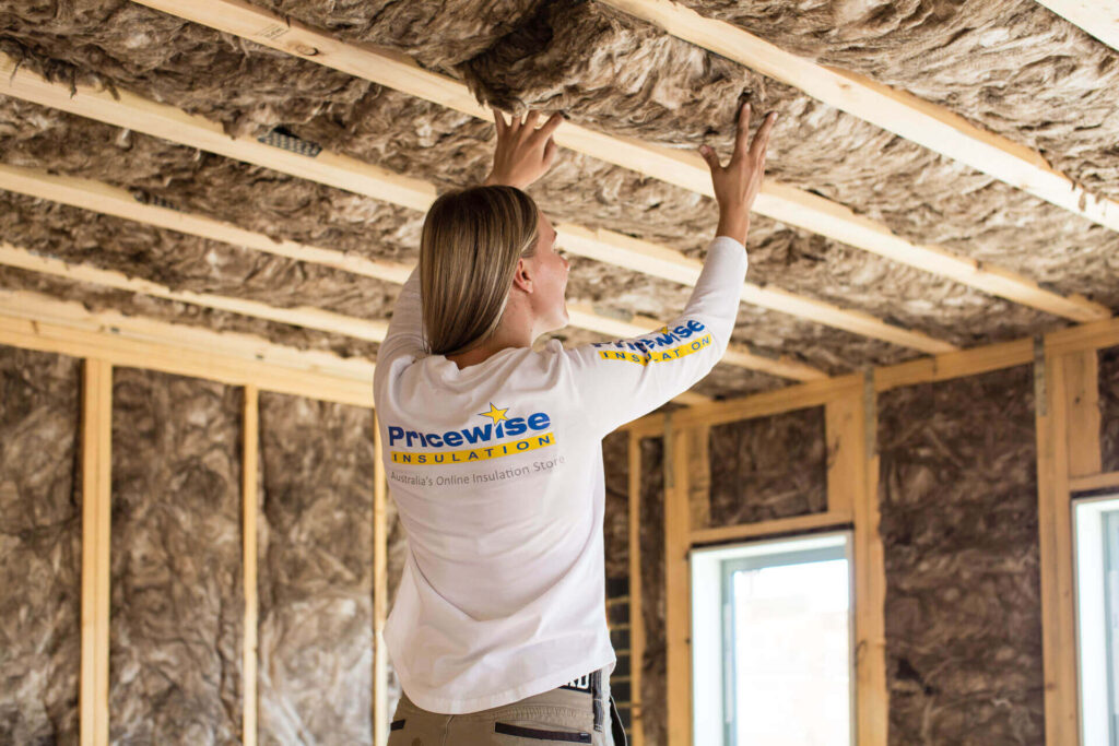image of a woman installing insulation