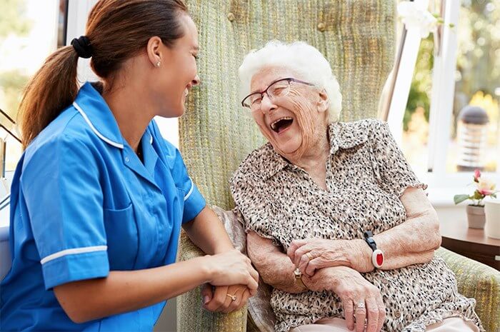 Image of a healthcare assistant working with an elderly patient