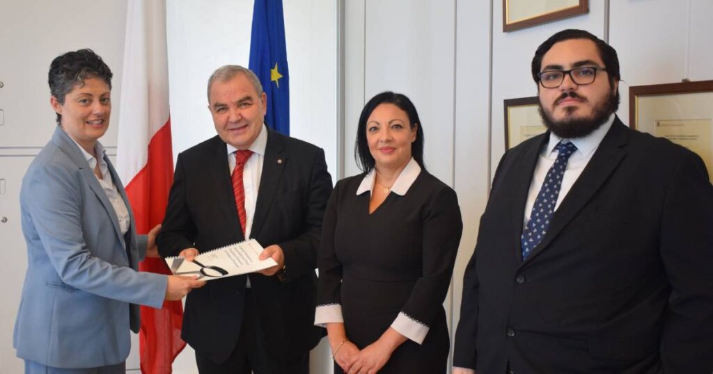 Image of documents being presented after moving to Malta