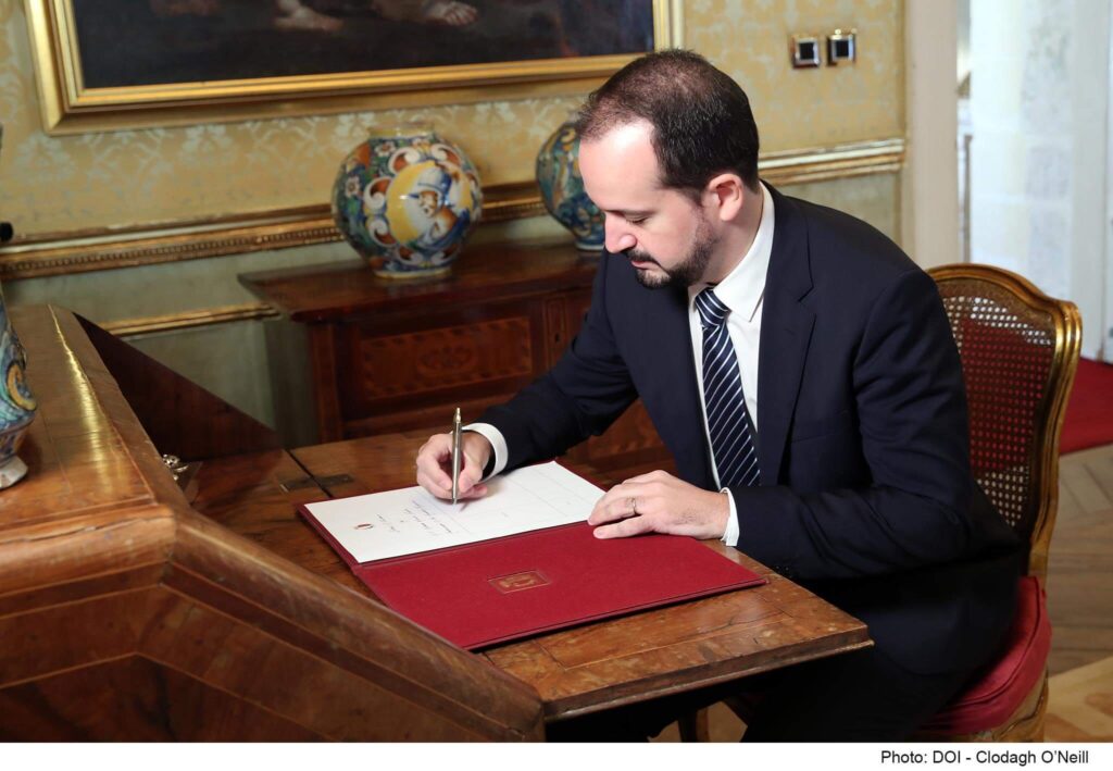 Image of an official document being signed by a malta immigration official