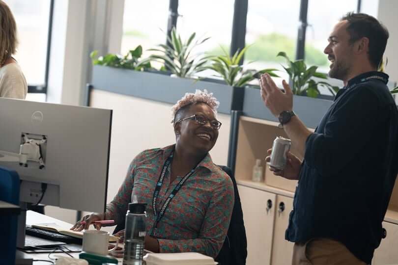 Image of colleagues learning from each other in a workplace