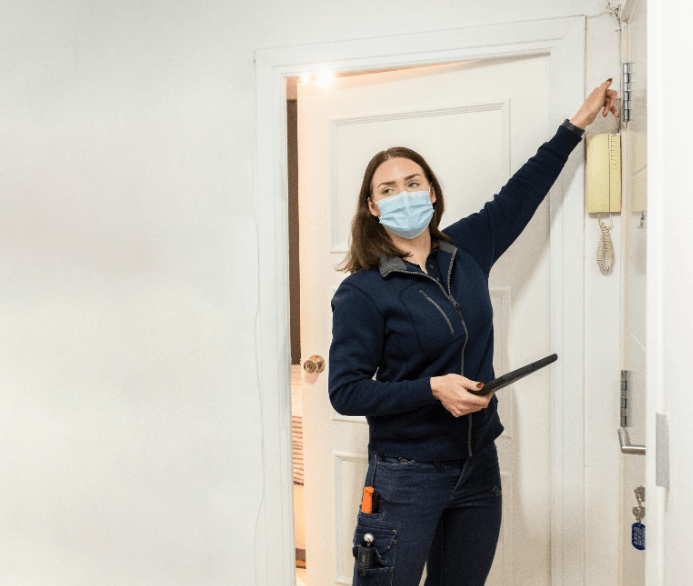 Image of a female inspector taking a tour with a buyer around a property for sale in Spain