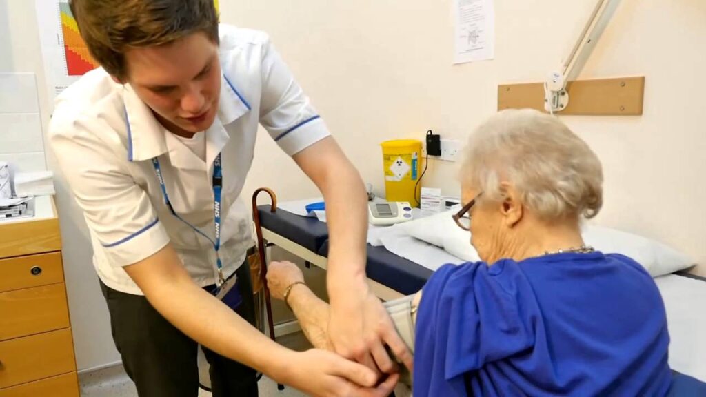 Image of a healthcare assistant working with an elderly patient