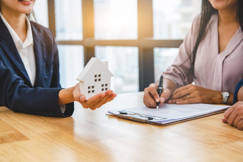 Image of a mortgage banker discussing mortgage financing with a couple.