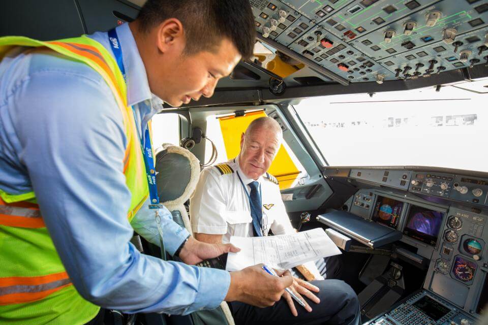 Image of a flight operations manager working with a pilot