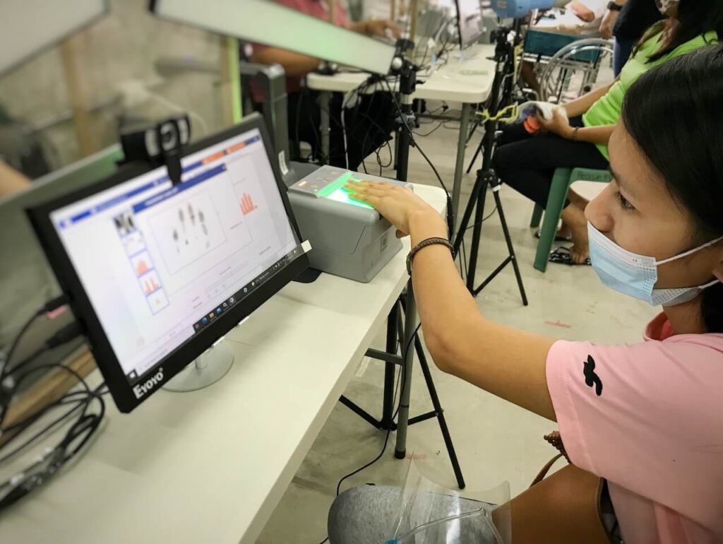 Image of a woman getting her biometric capture done before moving to Denmark