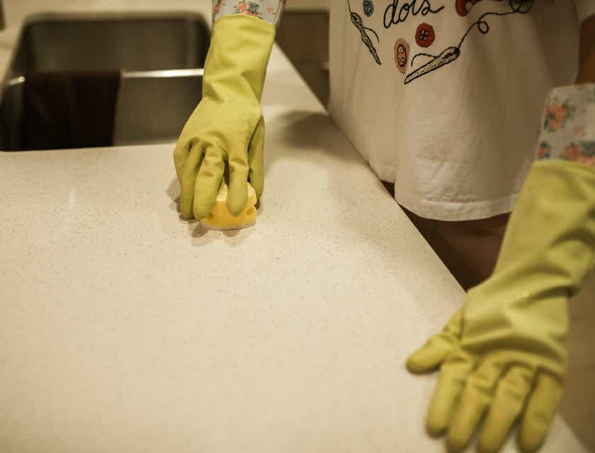 Image of a house sitter working by polishing a table surface