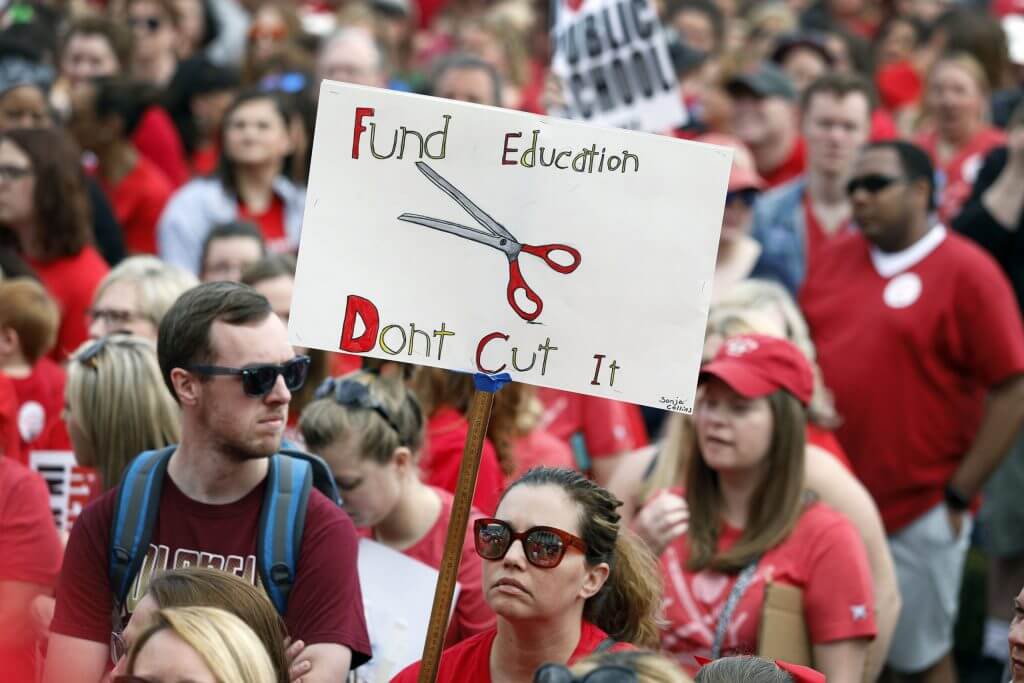 Image of teachers protesting due to low level of educational funding