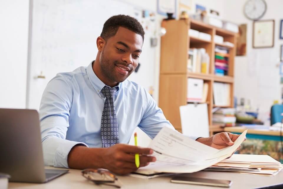 Image of a teacher doing administrative work in school