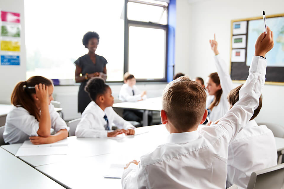 Image of a teacher in the UK moderating over a class