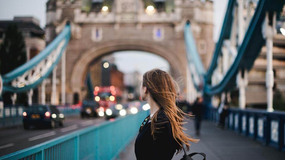 Image of a lady at the tower bridge in London after moving to the UK