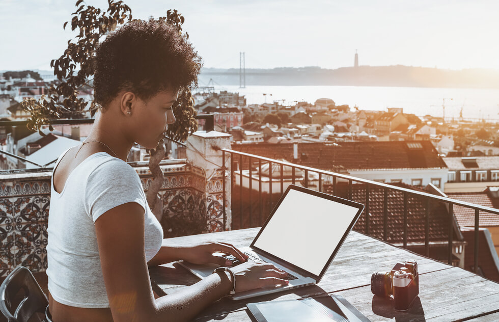 Image of a lady working remotely after moving to Portugal