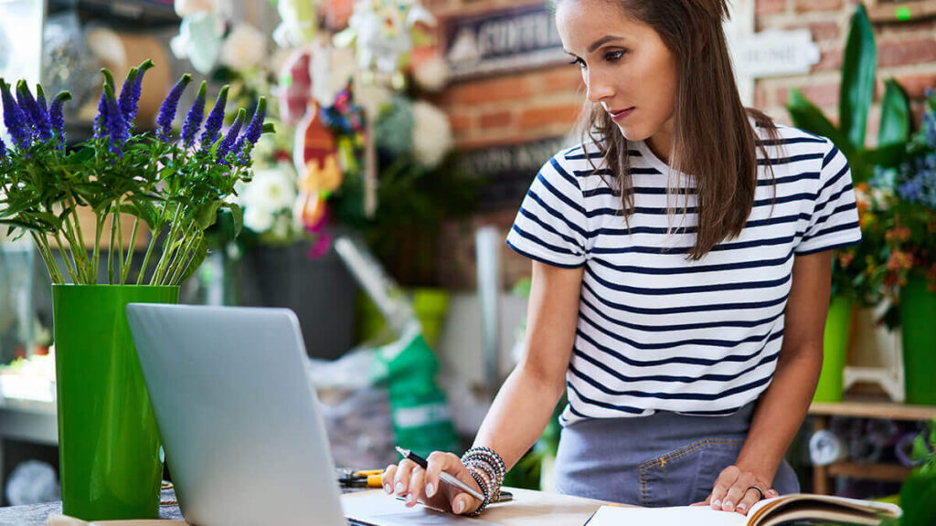 Image of a woman who is self-employed. Managing her business