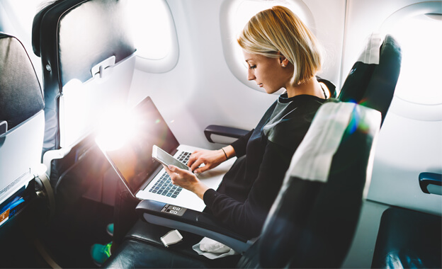 Image of a female expat working on a flight while moving to Sweden