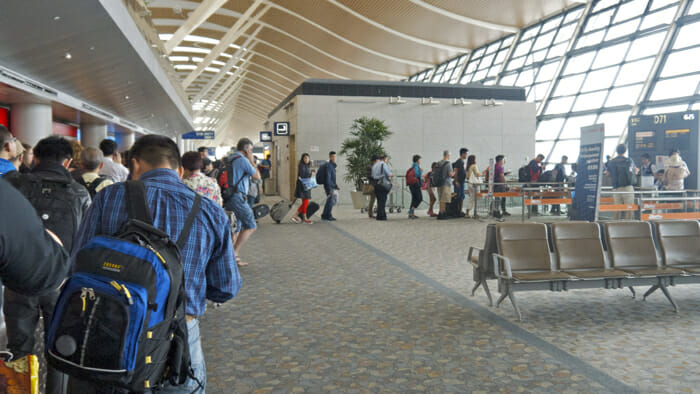 Image of people at the airport moving to Switzerland