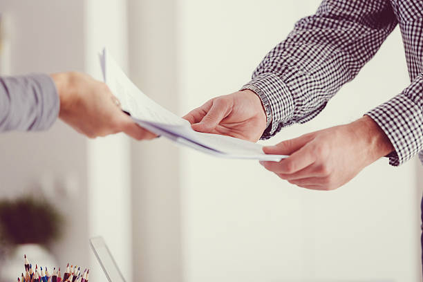 Image of an individual submitting a set of supporting documents