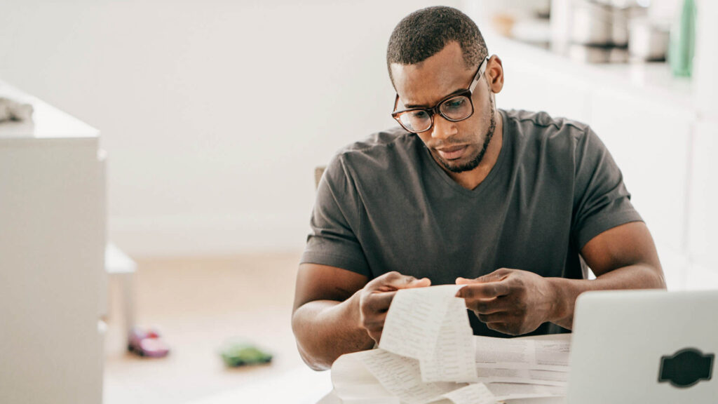 Image of a man paying for his Swiss visa application fee to complete his plans for moving to Switzerland