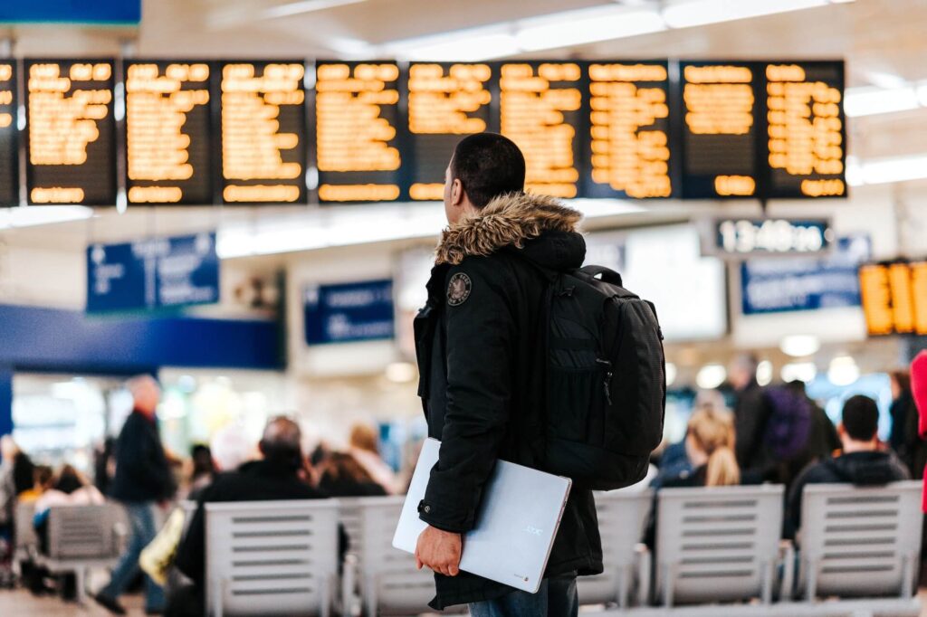 A man waiting for his flight to be announced while in the airport