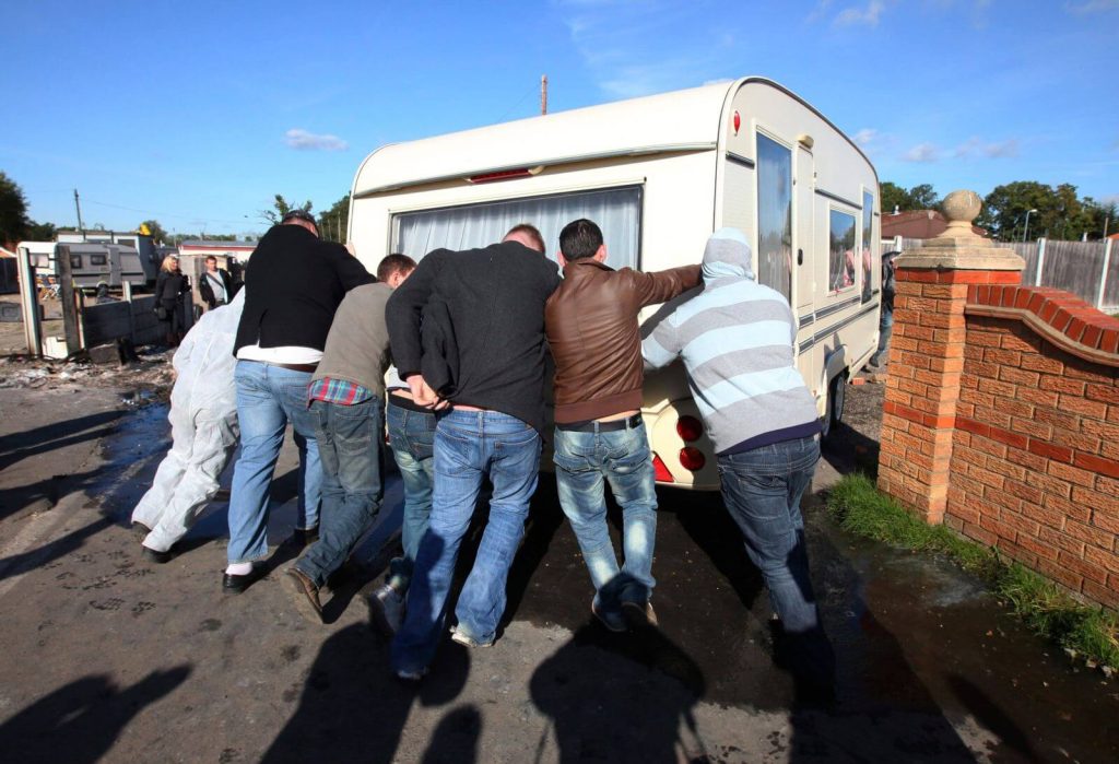 Irish travellers pushing a caravan