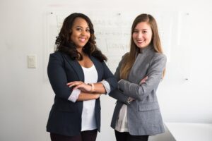 A black woman and a white woman who are both recipients of Intesa Sanpaolo's community outreach program